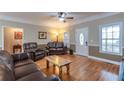 Spacious living room featuring hardwood floors, ceiling fan, and a comfortable seating area at 2208 Clarendon Ne Ct, Conyers, GA 30012