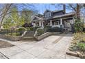 Lovely home with mature trees, a brick driveway, and a wrought iron fence at 289 9Th Ne St, Atlanta, GA 30309