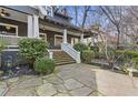 Lovely front exterior featuring a stone walkway, lush landscaping, and a welcoming porch at 289 9Th Ne St, Atlanta, GA 30309