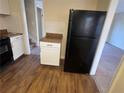 Cozy kitchen with wood floors, granite countertops, and black appliances at 2976 Nelson Dr, Duluth, GA 30096