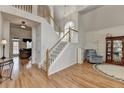 Stunning foyer with hardwood floors, staircase, natural light and an open view to the living room at 4260 River Club Dr, Cumming, GA 30041