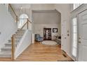 Elegant foyer featuring hardwood floors, staircase, natural light and a view into the living room at 4260 River Club Dr, Cumming, GA 30041