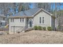 Charming exterior view of home featuring an attached garage and landscaped yard at 1975 Hunt Crossing Ct, Lawrenceville, GA 30043