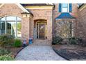 Charming brick home entrance with an arched doorway and brick paver pathway at 359 Flatstone Sw Way, Marietta, GA 30064