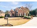 Brick two-story home with manicured landscaping and traditional architectural details at 359 Flatstone Sw Way, Marietta, GA 30064