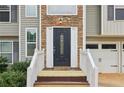 Close-up of a front door with decorative glass, stone accents, and a welcoming entrance at 65 Randall Dr, Rockmart, GA 30153