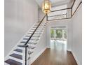 Entry way with a staircase and beautiful chandelier, leading to an area with lots of natural light at 1139 Tennyson Ne Pl, Brookhaven, GA 30319