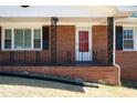 Close-up of the brick home's front porch with a red front door at 1276 Kingsview Se Cir, Smyrna, GA 30080