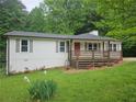 A charming home with white siding, a cozy front deck, and well-manicured lawn at 147 Mildred Ct, Dallas, GA 30157