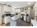 Modern kitchen with stainless steel appliances, granite countertops, and a stylish kitchen island at 2114 Fellowship Rd, Tucker, GA 30084
