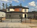 Contemporary two-story home featuring a gated driveway and modern architectural details at 2551 Kilgore Rd, Buford, GA 30519