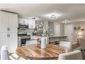 Bright dining space featuring a round wooden table, connecting to the modern kitchen with stainless steel appliances at 2814 Pine Meadow Dr, Marietta, GA 30066