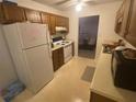 This kitchen features a white fridge, electric stove and wood cabinetry at 8538 Westchester Dr, Douglasville, GA 30134