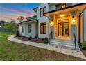 Gorgeous front entrance featuring modern black framed windows, minimalist landscaping, and striking wall sconces at 3968 Ashford Dunwoody, Brookhaven, GA 30319