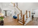 Bright foyer with wood floors, staircase with white spindles, and views into other rooms at 2039 Fisher Ne Trl, Atlanta, GA 30345