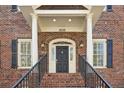 Inviting entryway with black door, white trim, and arched transom window under house number 2039 at 2039 Fisher Ne Trl, Atlanta, GA 30345