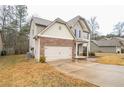 Charming two-story home featuring a well-manicured lawn, stone accents, and an attached two-car garage at 2534 Grayton Loop, Villa Rica, GA 30180