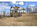 Attractive two-story home features a well-maintained lawn, inviting entrance and partial stone facade at 64 Roberson Ne Dr, Cartersville, GA 30121