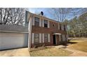 Traditional brick home featuring white shutters, mature trees, and an attached garage at 1226 Samuel Dr, Norcross, GA 30093