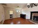 Living room featuring hardwood floors, a brick fireplace, and natural light from the window at 1226 Samuel Dr, Norcross, GA 30093