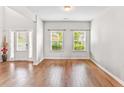 Bright and airy living room with hardwood floors, and natural light through large windows at 2167 Dodson Woods Dr, Fairburn, GA 30213