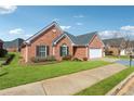 Beautiful single-story brick home with a well-maintained lawn, attached garage and black window shutters at 219 Prominent Loop, Mcdonough, GA 30253