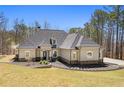 Beautiful exterior of a home with a manicured lawn and elegant landscaping at 3141 Buck Branch Sw Rd, Conyers, GA 30094
