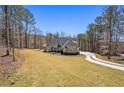 Beautifully landscaped property features a circular driveway and a well-maintained lawn at 3141 Buck Branch Sw Rd, Conyers, GA 30094