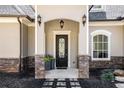 Inviting front entrance features a beautifully crafted door with elegant stone accents at 3141 Buck Branch Sw Rd, Conyers, GA 30094