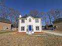 Charming two-story home featuring a blue front door and nice landscaping at 5180 Oaktree Trl, Lithonia, GA 30038