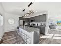 Stylish kitchen featuring gray cabinets, a granite countertop island with seating, and modern pendant lighting at 2000 Ocean Nw Dr, Atlanta, GA 30318