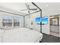 Bright bedroom with a four-poster bed, a ceiling fan, and an en-suite bathroom at 2000 Ocean Nw Dr, Atlanta, GA 30318