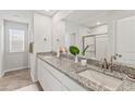 Elegant bathroom showcasing double sinks with granite countertops and a glass-enclosed shower for a spa-like experience at 407 Newland Way, Acworth, GA 30102