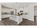 Modern kitchen featuring a center island with seating, stainless steel appliances, and ample cabinet space at 407 Newland Way, Acworth, GA 30102