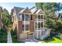 Beautiful home featuring a well-manicured lawn and a unique double-decker porch design at 2533 Briers North Dr, Atlanta, GA 30360