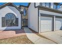 Close up of the home's entryway and two-car garage with white doors and black trim at 3291 Quincey Xing, Conyers, GA 30013