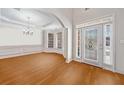 Dining room featuring hardwood floors, tray ceiling, and bay window at 2528 Picket Fence Ln, Snellville, GA 30078