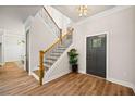 Bright foyer with hardwood floors, a modern staircase, and a stylish entryway at 2788 Browns Mill Se Rd, Atlanta, GA 30354