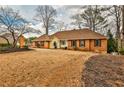 Attractive brick home featuring a manicured lawn, dark shutters, and a welcoming front entrance at 573 Ripplewater Sw Dr, Marietta, GA 30064