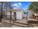 Back of home showcasing a wooden deck with stairs, perfect for outdoor entertaining at 6219 Holly Ann Se St, Acworth, GA 30102