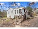 Back of home with wooden deck, stairs, and access to what looks like a basement door at 6219 Holly Ann Se St, Acworth, GA 30102