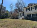 Charming two-story home with a brick exterior, trimmed black shutters and a well-maintained front yard at 6470 Wright Cir, Atlanta, GA 30328