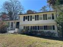 Charming two-story home with a brick exterior, trimmed black shutters and a well-maintained front yard at 6470 Wright Cir, Atlanta, GA 30328