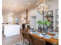 Eat-in kitchen dining area complemented with a stylish table, chairs, and globe light fixture at 6505 Cortland Walk, Alpharetta, GA 30005