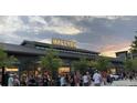 A bustling retail space with Halcyon signage against an evening sky attracting many pedestrians at 6505 Cortland Walk, Alpharetta, GA 30005