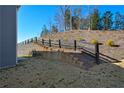 Backyard featuring a retaining wall with fence providing privacy and style at 67 Highgrove Way, Dallas, GA 30157