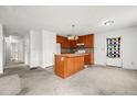 Open kitchen with wood cabinets, a central island, and direct access to other rooms at 306 Birch St, Canton, GA 30114