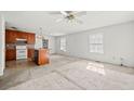 Open-concept living space featuring a ceiling fan, two windows, and access to the kitchen area at 306 Birch St, Canton, GA 30114