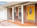 Inviting front porch with seating area and a bright yellow front door at 3890 Cherrydale Se Ln, Smyrna, GA 30082