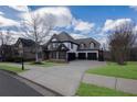 Beautiful two-story home with a three-car garage, stone accents, and well-maintained landscaping at 2077 Towne Mill Ave, Canton, GA 30114